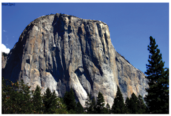 A sign on the side of a mountain  Description automatically generated