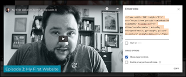 A screenshot displays a YouTube embed screen. A video is displayed which is paused. An embed video dialog box is present on the right side of the page. An embed code is present on the top portion of the dialog box.